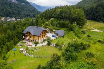 an aerial view of a house in the mountains at Apartment Pod Skalco in Jesenice