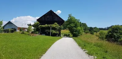 a dirt road leading to a barn on a field at Hillside Bio Resort Delux Apartments in Šešče pri Preboldu