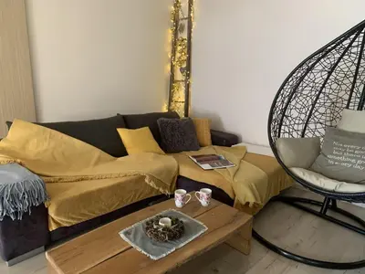 a living room with a couch and a chair at Hillside Bio Resort Delux Apartments in Šešče pri Preboldu