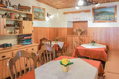 a dining room with two tables and a kitchen at Farm Holidays Povsin in Bled