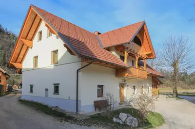 a white house with a red roof at Farm Holidays Povsin in Bled