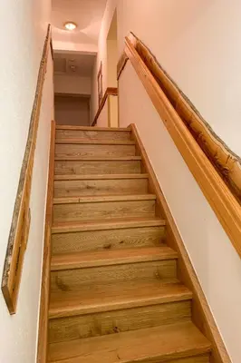 a staircase with wooden steps in a house at Guesthouse Draga in Begunje na Gorenjskem
