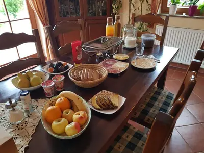a table with bowls of fruit and bread on it at Wine House Kaloh in Maribor