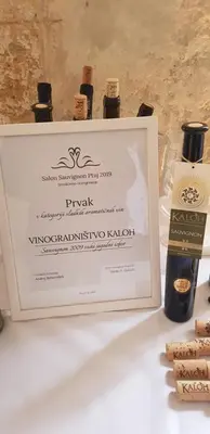 a framed picture of three bottles of wine at Wine House Kaloh in Maribor