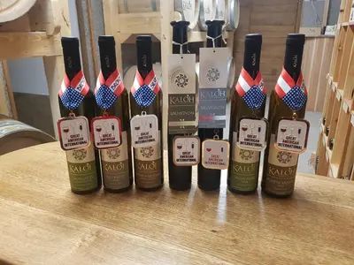a group of bottles of wine sitting on a table at Wine House Kaloh in Maribor