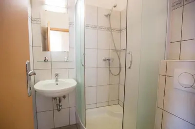 a bathroom with a shower and a sink at Hostel Sonce in Ptuj
