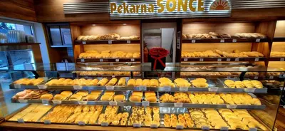 a bakery filled with lots of different types of bread at Hostel Sonce in Ptuj