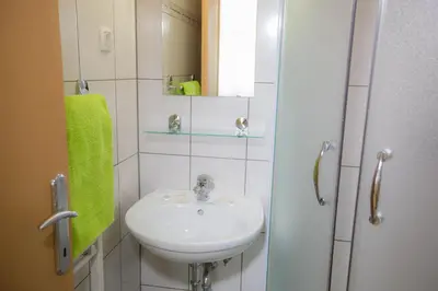 a bathroom with a sink and a mirror at Hostel Sonce in Ptuj