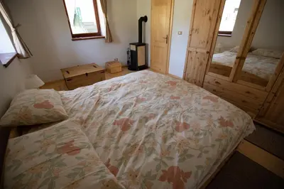 a bedroom with a bed with a floral comforter at Apartment Gaia in Lokve