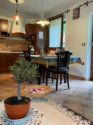 a kitchen and dining room with a table and chairs at Apartment Gaia in Lokve