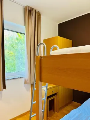 a bedroom with two bunk beds and a window at Villa Mari I in Maribor