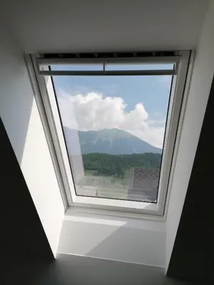 a window in a room with a view of a mountain at Apartment Marjetka in Žirovnica