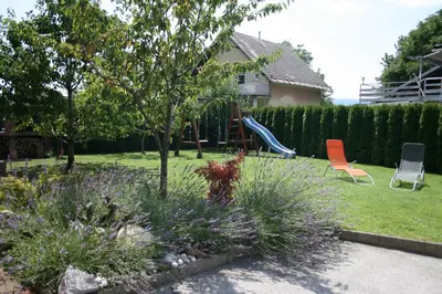 a backyard with a playground with two chairs and a slide at Apartment Marjetka in Žirovnica