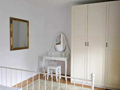 a bedroom with a dressing table and a mirror at Apartments Vila Marjetica in Bled
