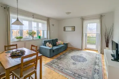 a living room with a table and a couch at Apartments Vila Marjetica in Bled