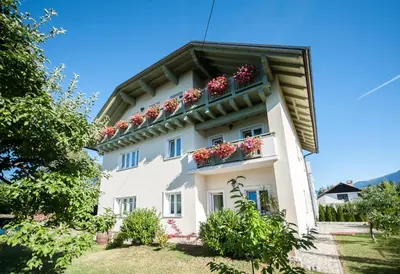a white building with flower boxes on it at Apartments Vila Marjetica in Bled