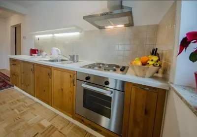 a kitchen with a stove and a bowl of fruit at Apartments Vila Marjetica in Bled