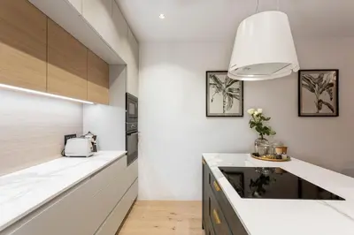 a kitchen with white counters and a white counter top at Apartment Zoja in Kranjska Gora