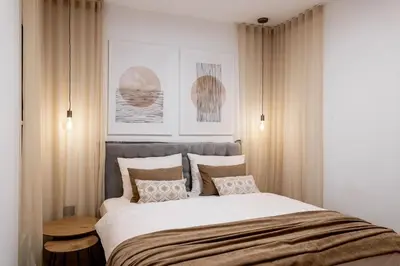 a bedroom with a large bed with white sheets and pillows at Apartment Zoja in Kranjska Gora