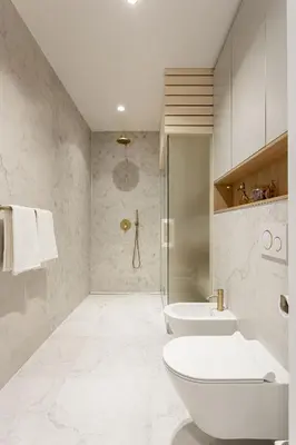 a white bathroom with a toilet and a shower at Apartment Zoja in Kranjska Gora