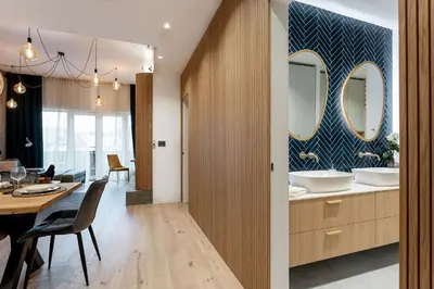 a kitchen and dining room with a dining table and mirror at Apartment Zoja in Kranjska Gora