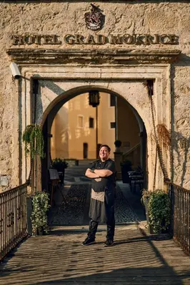 a man standing in the entrance to a building at Mokrice Castle Estate in Čatež ob Savi