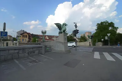 a statue of a woman with an umbrella on a street at RIVER SIDE CENTRAL MARKET - Eclipse superior apartment in Ljubljana