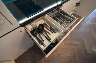 a kitchen drawer with utensils on a counter at RIVER SIDE CENTRAL MARKET - Eclipse superior apartment in Ljubljana