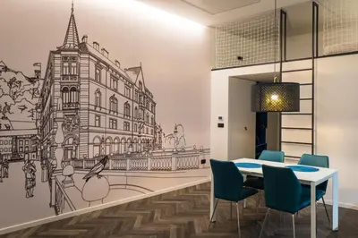 a dining room with a table and chairs and a wall mural at RIVER SIDE CENTRAL MARKET - Eclipse superior apartment in Ljubljana