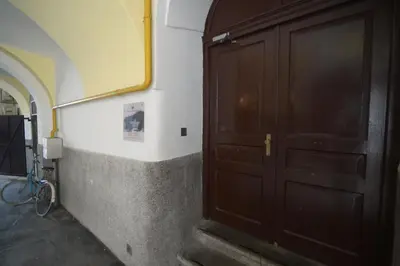 a large wooden door in a room with stairs at RIVER SIDE CENTRAL MARKET - Eclipse superior apartment in Ljubljana