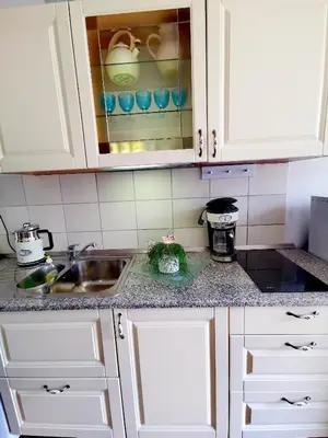 a kitchen with white cabinets and a sink at Apartma MB-Center in Maribor