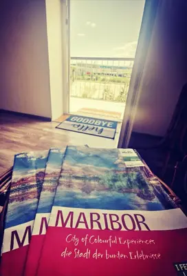 a book sitting on a table in front of a door at Apartma MB-Center in Maribor