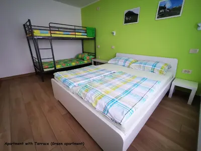 a bedroom with a bed and a bunk bed at Apartment and room Anica in Tolmin