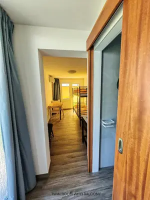 a hallway with a door open to a room at Apartment and room Anica in Tolmin