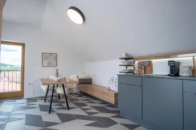 a kitchen with a checkered floor and a table at Stella Sky in Ljubljana