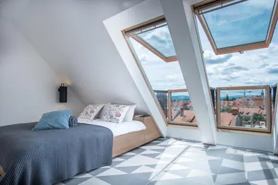 a bedroom with a bed and a large window at Stella Sky in Ljubljana