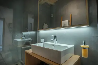 a bathroom with a white sink and a mirror at Stella Sky in Ljubljana