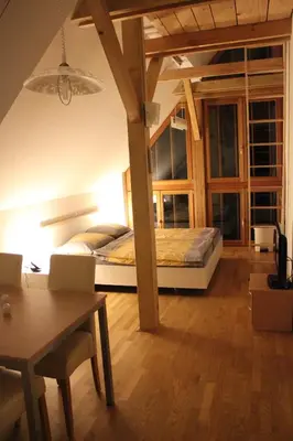 a bedroom with a bed and a desk and a table at Guest accomodation Klancar in Ig