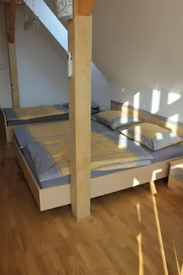 two bunk beds in a room with wooden floors at Guest accomodation Klancar in Ig