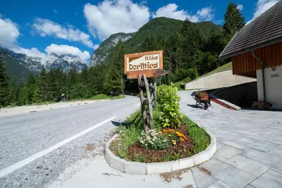 a sign for a hotel on the side of a road at House DorMica in Trenta