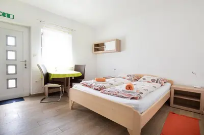 a bedroom with a bed and a desk and a window at House DorMica in Trenta