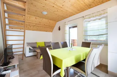 a dining room with a yellow table and chairs at House DorMica in Trenta