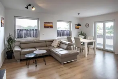 a living room with a couch and a table at Apartments Vila Apolonia in Ljubljana