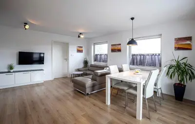 a living room with a table and a couch at Apartments Vila Apolonia in Ljubljana