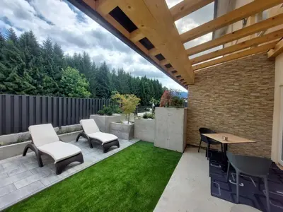 a patio with a table and chairs and grass at GOSTILNA S PRENOČIŠČI PAV in Rakek