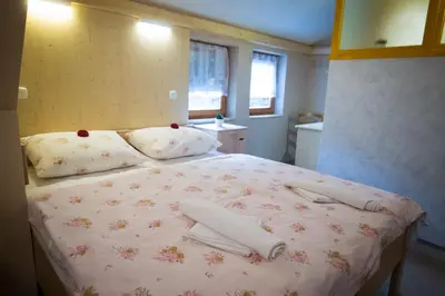 a bedroom with a bed with towels on it at GLUTEN FREE Bed & Breakfast Dežela Okusov in Ljubljana
