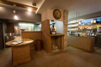 a kitchen with a counter and a clock on the wall at GLUTEN FREE Bed & Breakfast Dežela Okusov in Ljubljana