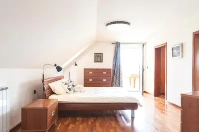 a bedroom with a bed and a staircase at Vila Izabela in Križevci pri Ljutomeru
