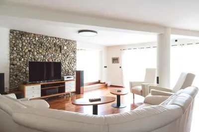 a living room with a couch and a tv at Vila Izabela in Križevci pri Ljutomeru