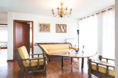 a living room with a couch and a table and chairs at Vila Izabela in Križevci pri Ljutomeru